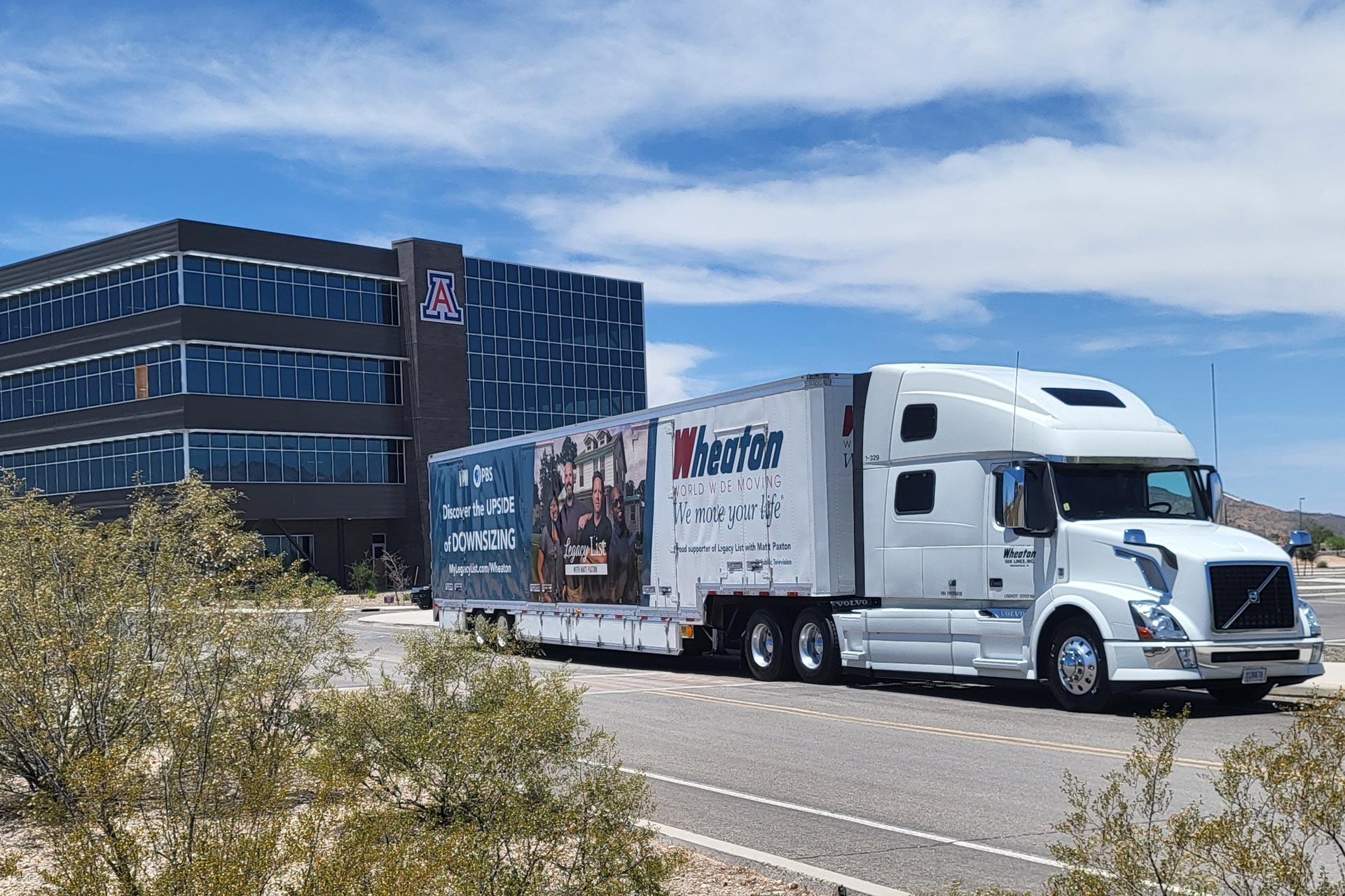 Wheaton Worldwide Moving truck driving away from an office building