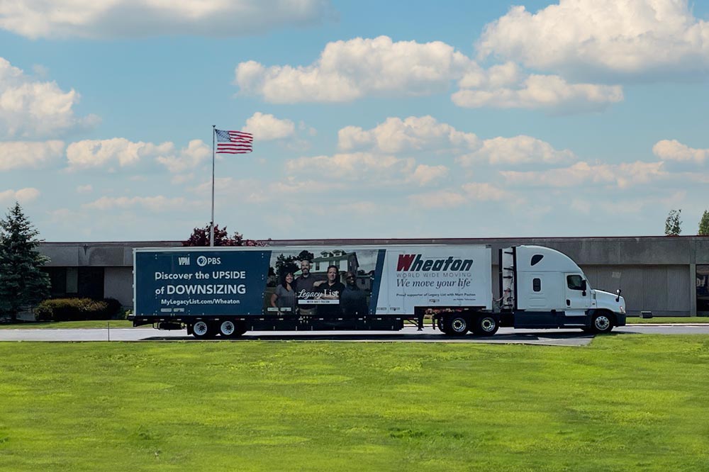 Wheaton Worldwide Moving truck parked in front of an office
