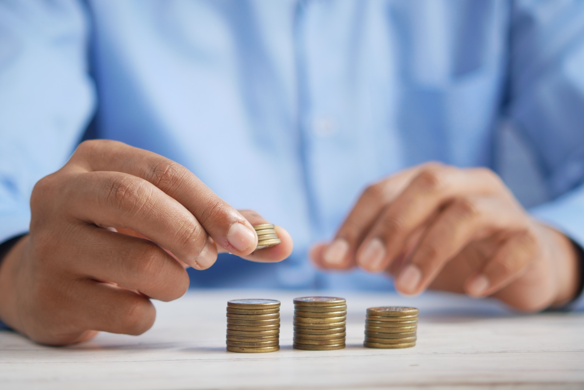 Close-up shot on man's hands rolling coins