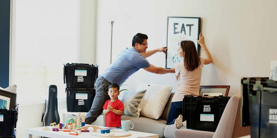 Couple with young child unpacking boxes after a move