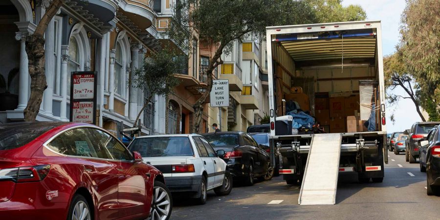 Moving truck parked on a crowded city street