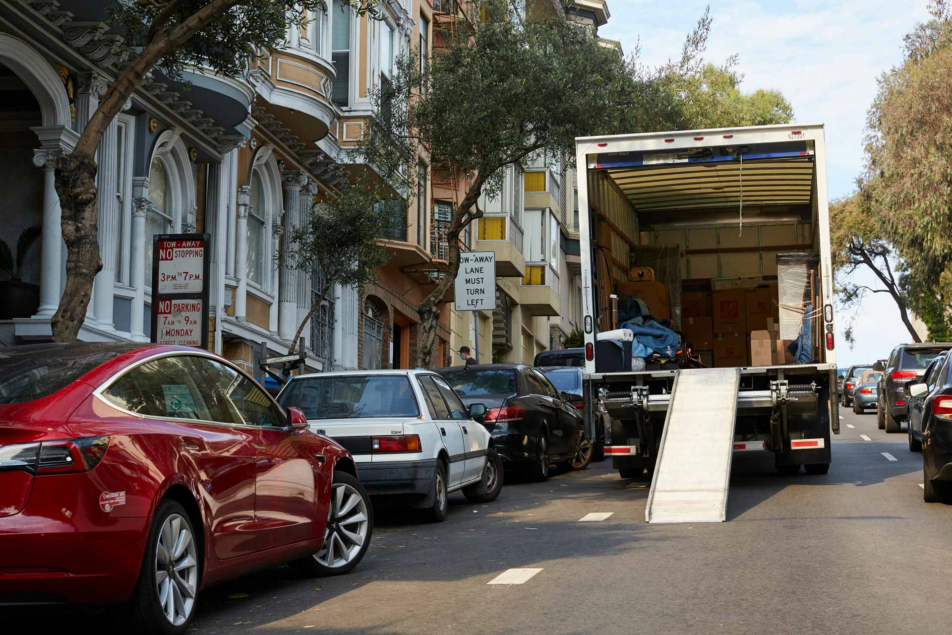 Moving truck parked on a crowded city street
