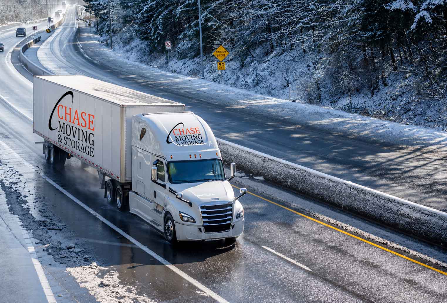 Chase Moving and Storage truck driving down an icy mountain road